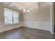 Elegant dining room with wainscoting, gray flooring, and a chandelier at 116 Sophie Cir, Locust Grove, GA 30248