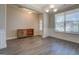 Well-lit dining room featuring wainscoting, hardwood floors, a chandelier, and a wooden cabinet at 116 Sophie Cir, Locust Grove, GA 30248