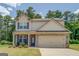 Charming two-story home featuring a brick facade, neutral siding, and a two-car garage at 116 Sophie Cir, Locust Grove, GA 30248