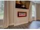 Cozy fireplace in a living room with windows and neutral-colored drapes at 116 Sophie Cir, Locust Grove, GA 30248