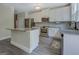 Stylish kitchen featuring white cabinets, stainless steel appliances, and a granite island at 116 Sophie Cir, Locust Grove, GA 30248