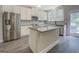 Bright kitchen with granite countertops, stainless steel appliances, and a center island at 116 Sophie Cir, Locust Grove, GA 30248
