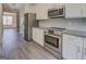 Well-designed kitchen features stainless steel appliances, granite counters, and white cabinetry at 116 Sophie Cir, Locust Grove, GA 30248