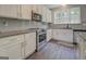 Well-equipped kitchen boasts granite countertops, stainless steel appliances, and ample cabinet space at 116 Sophie Cir, Locust Grove, GA 30248