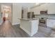 Beautiful kitchen with granite island, stainless steel appliances, and open access to hallway at 116 Sophie Cir, Locust Grove, GA 30248