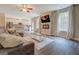 Inviting living room featuring sleek flooring, a large sofa, and a kitchen with stainless appliances at 116 Sophie Cir, Locust Grove, GA 30248