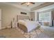 Bright main bedroom with cozy carpet, tray ceiling, and a large window at 116 Sophie Cir, Locust Grove, GA 30248