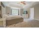 Spacious main bedroom with tray ceiling, fan, carpet, and generous natural light at 116 Sophie Cir, Locust Grove, GA 30248