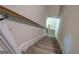 Carpeted stairway with a wooden railing leading to the upper level of the home at 116 Sophie Cir, Locust Grove, GA 30248