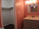 Bathroom featuring vanity with decorated mirror and walk-in closet at 2498 Robinhood Dr, Ellenwood, GA 30294