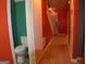 Bathroom with commode and colorful geometric pattern flooring at 2498 Robinhood Dr, Ellenwood, GA 30294
