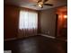 Bright bedroom featuring a ceiling fan and dark floors with an adjacent bathroom at 2498 Robinhood Dr, Ellenwood, GA 30294
