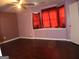 Cozy bedroom featuring wood floors, ceiling fan, and natural light, perfect for relaxation and rest at 2498 Robinhood Dr, Ellenwood, GA 30294