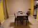Dining room area with a wooden table and chairs, plus neutral colors and earth tone tiled floors at 2498 Robinhood Dr, Ellenwood, GA 30294