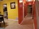 Hallway with neutral tile, leading to the kitchen, basement and stairway access at 2498 Robinhood Dr, Ellenwood, GA 30294
