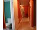 Hallway featuring tile floors, neutral walls, and access to a bathroom with toilet at 2498 Robinhood Dr, Ellenwood, GA 30294
