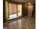 Living room with large bay windows and modern tile flooring at 2498 Robinhood Dr, Ellenwood, GA 30294