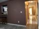 View of living room featuring tile floors, a bar, and view of a kitchen through an opening at 2498 Robinhood Dr, Ellenwood, GA 30294