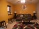 Living room with couch, side tables, bright yellow walls, and decorative rug at 2498 Robinhood Dr, Ellenwood, GA 30294
