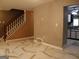Open-concept living room with modern flooring, staircase and a glimpse into the kitchen at 2498 Robinhood Dr, Ellenwood, GA 30294