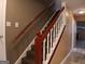 Interior staircase with red railings and carpeted steps leading to the upper floor at 2498 Robinhood Dr, Ellenwood, GA 30294