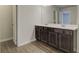 Bathroom vanity with double sinks, wood cabinets, and neutral countertops at 4454 Eastbrook Pl # 57B, Snellville, GA 30039
