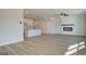 Open-concept living area with modern fireplace, white trim, and direct access to the kitchen at 4454 Eastbrook Pl # 57B, Snellville, GA 30039