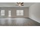 Bright and spacious living room with wood-look floors, ceiling fan, and access to backyard at 4454 Eastbrook Pl # 57B, Snellville, GA 30039
