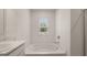 Bathroom featuring a soaking tub with a window at 1939 Van Allen Ct, Dacula, GA 30019