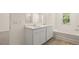 Bathroom featuring a double sink vanity and a soaking tub at 1939 Van Allen Ct, Dacula, GA 30019