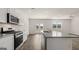 Contemporary kitchen with granite countertops, stainless steel appliances, and wood flooring at 1939 Van Allen Ct, Dacula, GA 30019