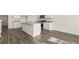 Open kitchen featuring gray wood floors, white cabinets, granite countertops, and stainless steel appliances at 1939 Van Allen Ct, Dacula, GA 30019