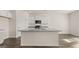 New kitchen with modern island, granite countertops, and stainless steel appliances at 1939 Van Allen Ct, Dacula, GA 30019