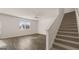 Open-concept living space features staircase and luxury vinyl plank flooring throughout at 1939 Van Allen Ct, Dacula, GA 30019