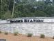 Brooks Station stone monument sign surrounded by lush trees and greenery at 1939 Van Allen Ct, Dacula, GA 30019