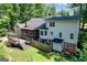 Aerial view of the home's backyard, featuring a deck, screened in porch and grassy lawn at 591 Clubwood Ct, Marietta, GA 30068
