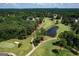 A picturesque aerial view of a lush golf course with a tranquil pond surrounded by trees at 591 Clubwood Ct, Marietta, GA 30068