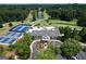 An aerial view showcases tennis courts and a golf course surrounding the clubhouse at 591 Clubwood Ct, Marietta, GA 30068