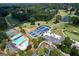 Stunning aerial view of community amenities including tennis courts, pools, and clubhouse surrounded by lush greenery at 591 Clubwood Ct, Marietta, GA 30068