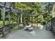 Relaxing back deck with a picnic table, overhead string lights, and a barbecue grill at 591 Clubwood Ct, Marietta, GA 30068