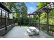 Inviting back deck features a picnic table with views of a well-manicured backyard at 591 Clubwood Ct, Marietta, GA 30068