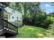 The home's backyard features a deck with stairs, a small storage shed, and a grassy lawn at 591 Clubwood Ct, Marietta, GA 30068