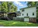 The home's backyard features a deck with stairs, a screened in porch, and a grassy lawn at 591 Clubwood Ct, Marietta, GA 30068