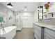 Bright bathroom showcasing a soaking tub, walk-in shower, and double sink vanity with gray marble countertop at 591 Clubwood Ct, Marietta, GA 30068