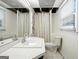 Simple bathroom with vintage white tile, a sink, toilet, and shower area with privacy curtain at 591 Clubwood Ct, Marietta, GA 30068