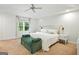 Large bedroom with an upholstered bench, a king bed, and natural light at 591 Clubwood Ct, Marietta, GA 30068