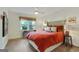 Bright bedroom with an orange bedspread, side tables, and a window view of nature at 591 Clubwood Ct, Marietta, GA 30068