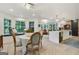 Dining room with a bay window seating area, hardwood floors, and an open layout to the kitchen and living room at 591 Clubwood Ct, Marietta, GA 30068