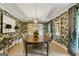 Formal dining room with wood floors, wallpaper, and a large wooden table at 591 Clubwood Ct, Marietta, GA 30068