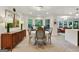 Dining room with a bay window seating area with backyard views, hardwood floors and stylish decor at 591 Clubwood Ct, Marietta, GA 30068